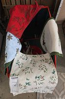 overall lot showing storage bag and assorted linens draped over edges