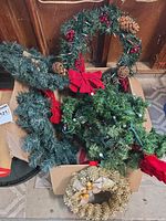 Group view showing large wreath, garland, small gold wreath in box
