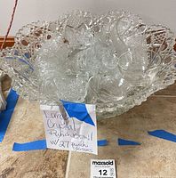 Punch bowl filled with cups showing cut pattern and scalloped rim