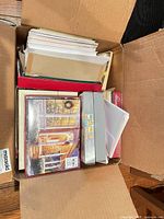 Open box showing assorted boxed and loose greeting cards