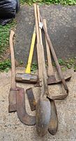 All seven hand tools laid out on ground