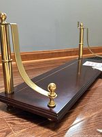 Shelf top facing down showing brass posts and supports