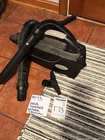 vacuum with hose, extension wand, crevice tool and lot tags