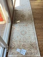 Full length view of runner rug on wood floor