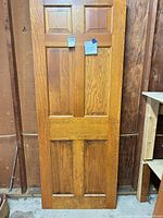 Front view of representative door showing 6-panel layout, finish, grain