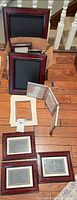 All frames, mats, and hinged frame laid out on floor