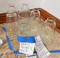 Eight clear glass globes grouped on countertop