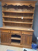 Front full view of pine hutch buffet showing shelves, drawers, doors