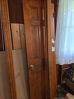Full view of solid wood 6-panel door with attached trim sections