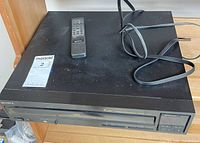 Front and top view of Sony 5-disc CD changer with remote and power cord
