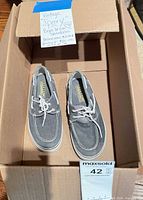 Pair of gray canvas Sperry youth boat shoes in box, top view