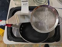 Overview of strainer, pan, spatula, tray with insert