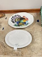 Both turkey platters on tile floor