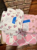 Stack showing both sheet sets and quilt
