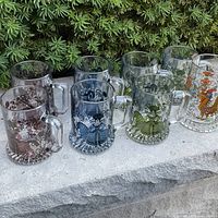 All eight hand-painted glass mugs displayed together