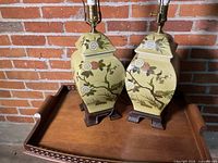 Front view of both matching ceramic lamps on wood bases