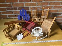Group shot of all wooden doll furniture pieces on table