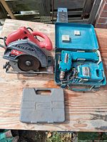 Group view: Skilsaw saw, open teal case with Makita drill & charger, Grey Blue-Point bit case