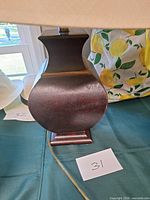 Side view of brown base showing shape and finish