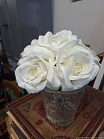 White faux rose arrangement in clear pressed-glass vase