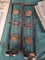 Pair of metal wall sconces showing full design