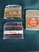 Three lighters: Winston chrome, The Great Ones brass, Office Interiors chrome