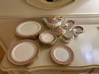Entire set stacked on dresser, showing plates and tea service pieces