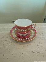 Cup on saucer showing pattern and gold trim