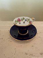 Cup on saucer, interior floral pattern visible