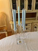 Frontal view of Nachtmann crystal candelabra with five blue candles