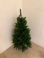 Full view of artificial Christmas tree in corner