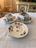 All seven Theodore Haviland pieces grouped on table