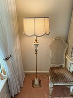 Full view of brass-tone floor lamp with shade
