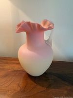 Full view of Burmese satin glass pitcher showing color gradient and handle