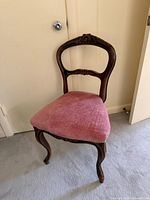 Full view of chair angled left showing frame, upholstery, and legs