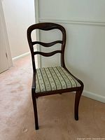 Front-left view of wooden side chair showing frame and seat
