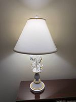 Lamp lit on tabletop showing full view with shade