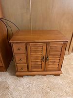 front view showing drawers, doors, finish, hardware