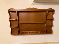 Front view of wall shelf showing overall design and compartments