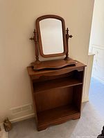 Full view of wooden shelf with mirror on top