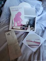 Device, box interior, instruction booklet, power adapter, lubricant tube, CD visible