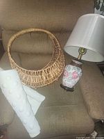 lamp, basket, and shelf liner rolls on chair