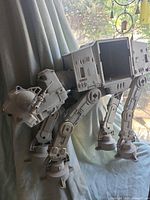 Left side view of gray AT-AT Walker showing legs and open body cavity