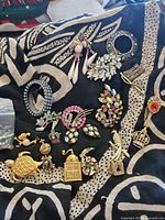 Group overview of all jewellery pieces on patterned fabric