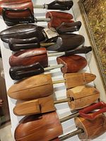 All five pairs of wooden shoehorns displayed on table
