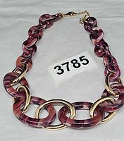 Full view of necklace laid flat showing link design and color