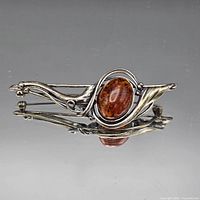 Front view showing brooch design and amber cabochon
