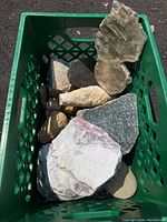 Top view of assorted rocks inside green crate