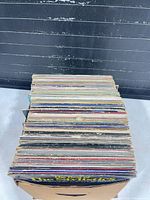 Stack of vinyl records in box, top view