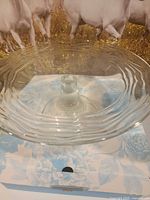 Top view of clear glass pedestal cake plate on box